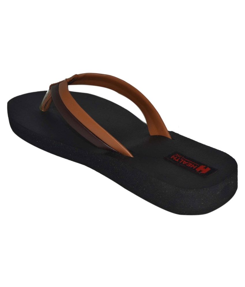 tan flip flops with black straps